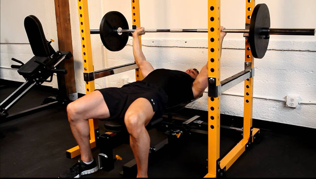 bench pressing in a rack