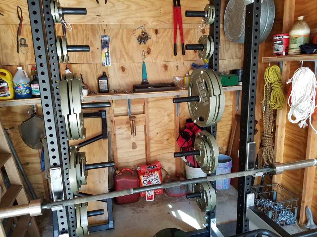 weight plate storage pegs on the back of a custom power rack