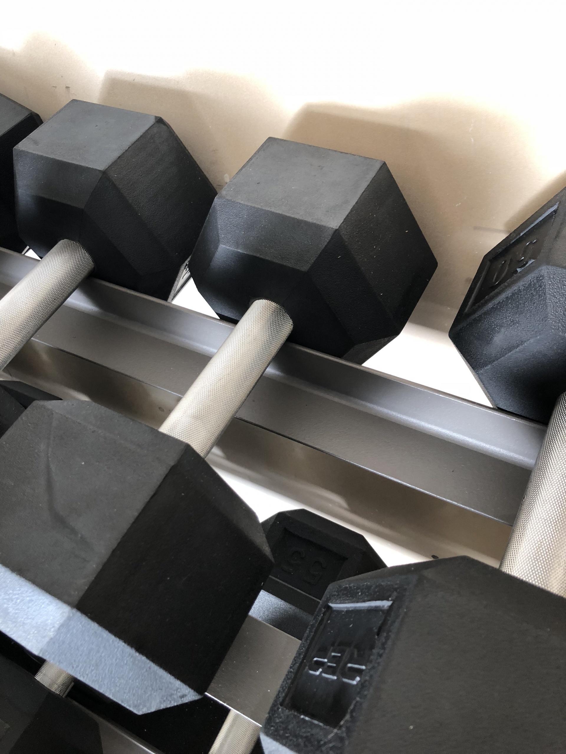 Rep rubber hexagon dumbbell set on XMark rack