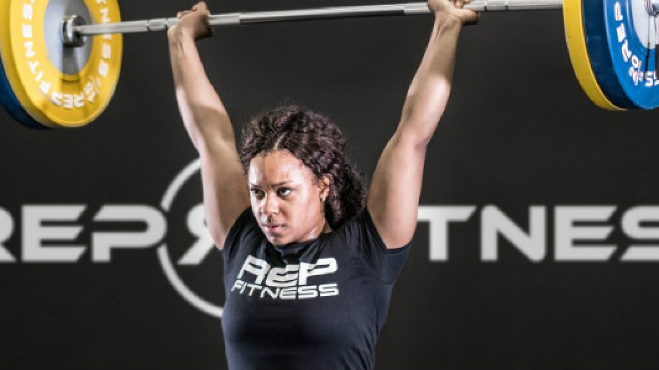 woman lifting olympic barbell woman lifting olympic barbell